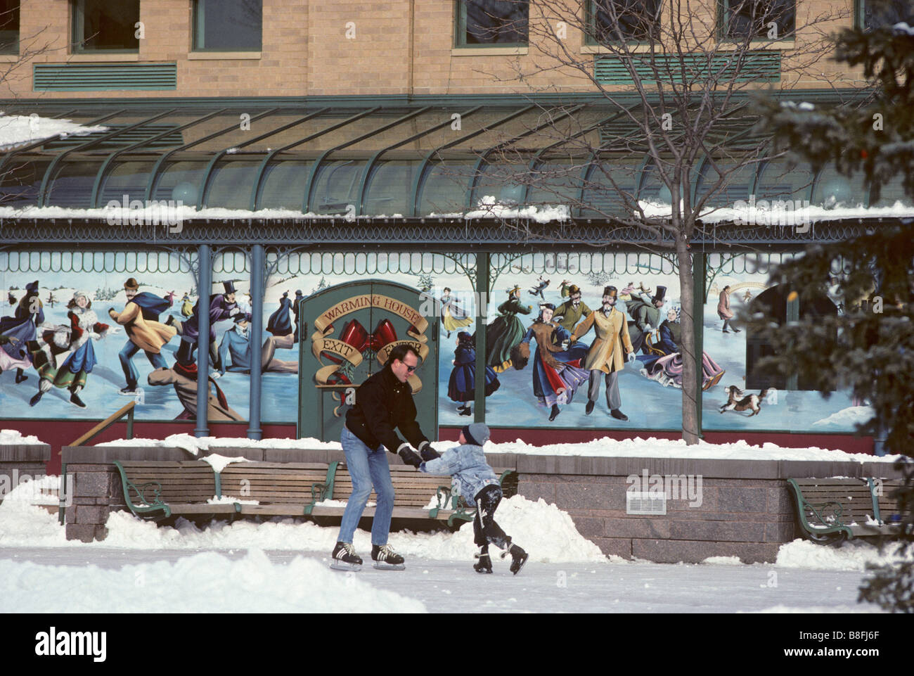 FATHER AND SON ICE SKATE AT RIVERPLACE, A COMPLEX OF SHOPS AND