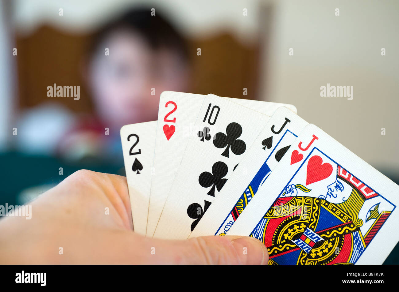 Man's hand holds two pair while playing poker Stock Photo
