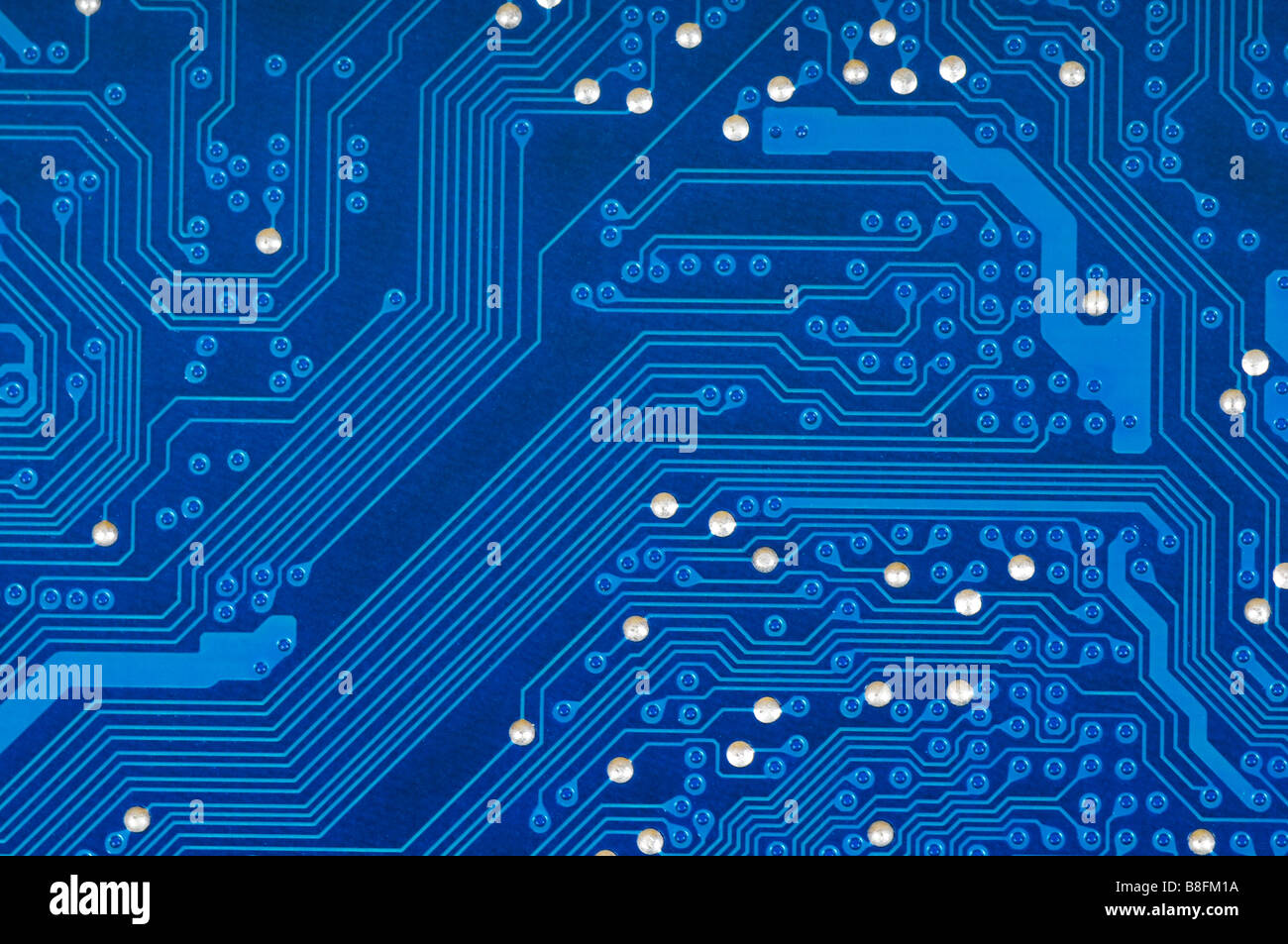 Detail of blue printed circuit board with silver studs. Stock Photo