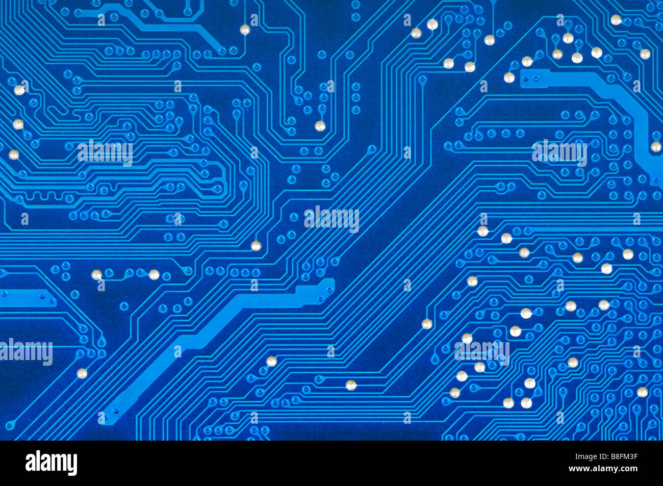 Detail of blue printed circuit board with silver studs. Stock Photo