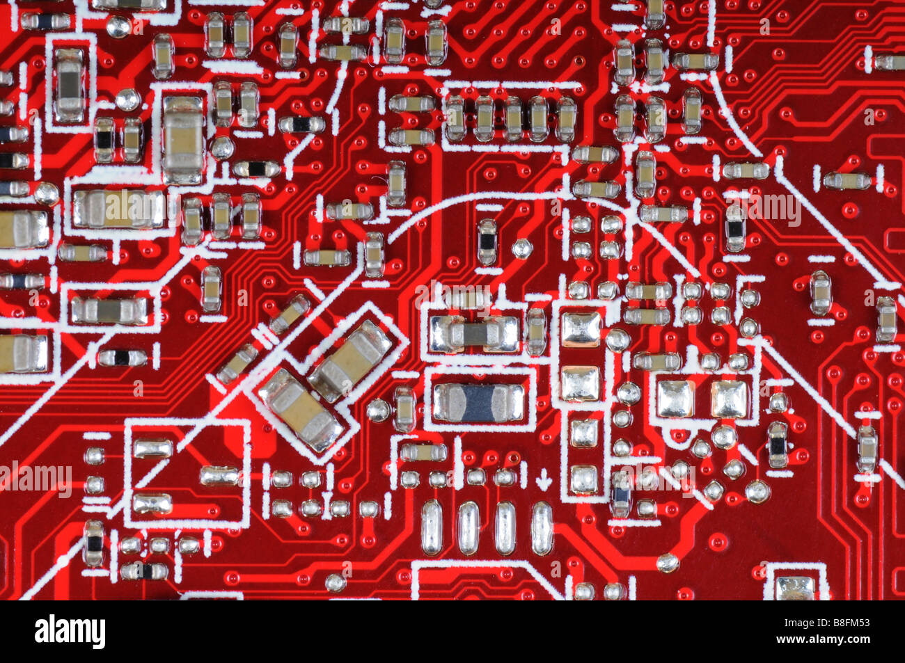 Detail of red printed circuit board with electronic components. Stock Photo
