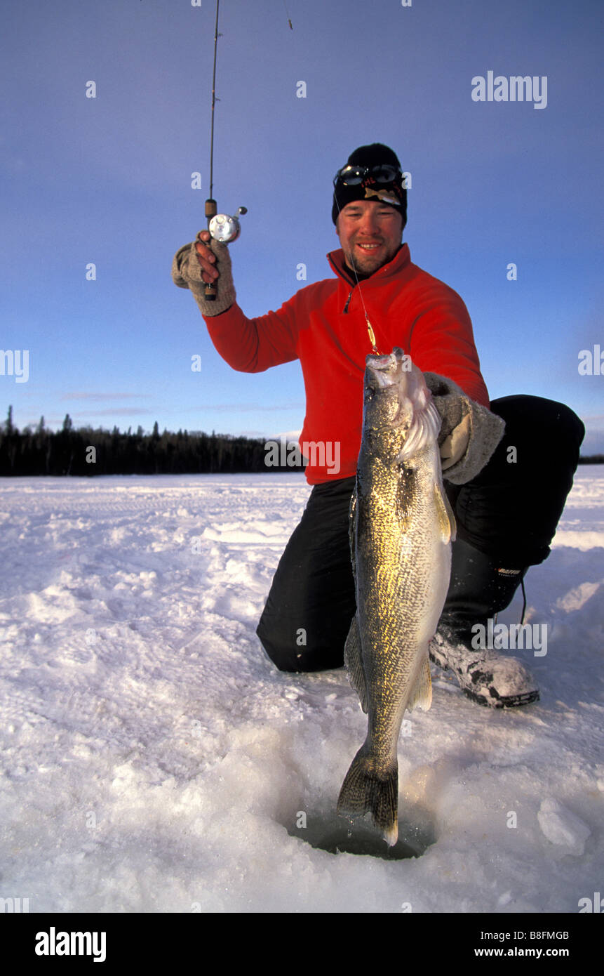 Man ice fishing walleye Stock Photo - Alamy