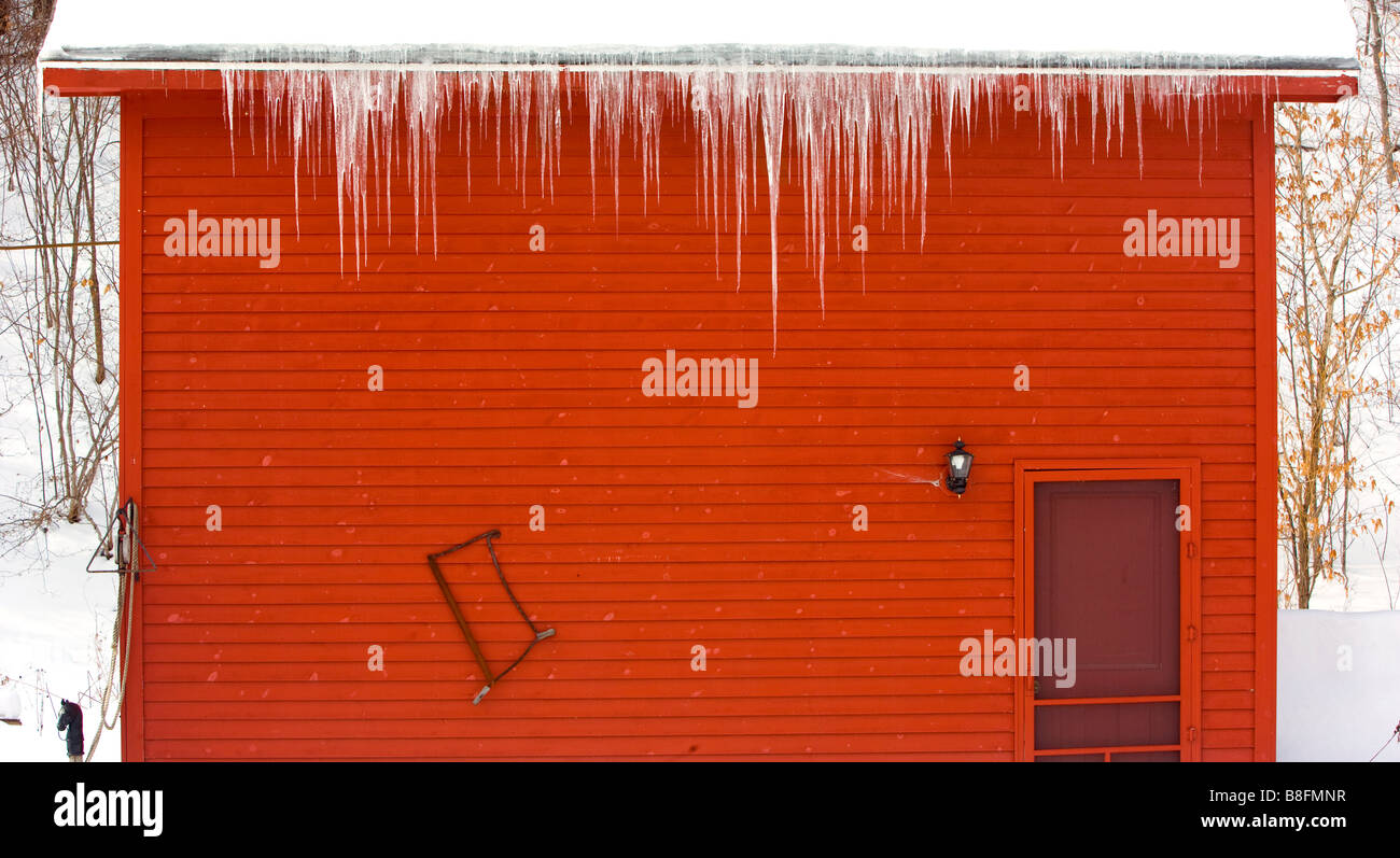 Icicles hanging from a Vermont barn roof Stock Photo