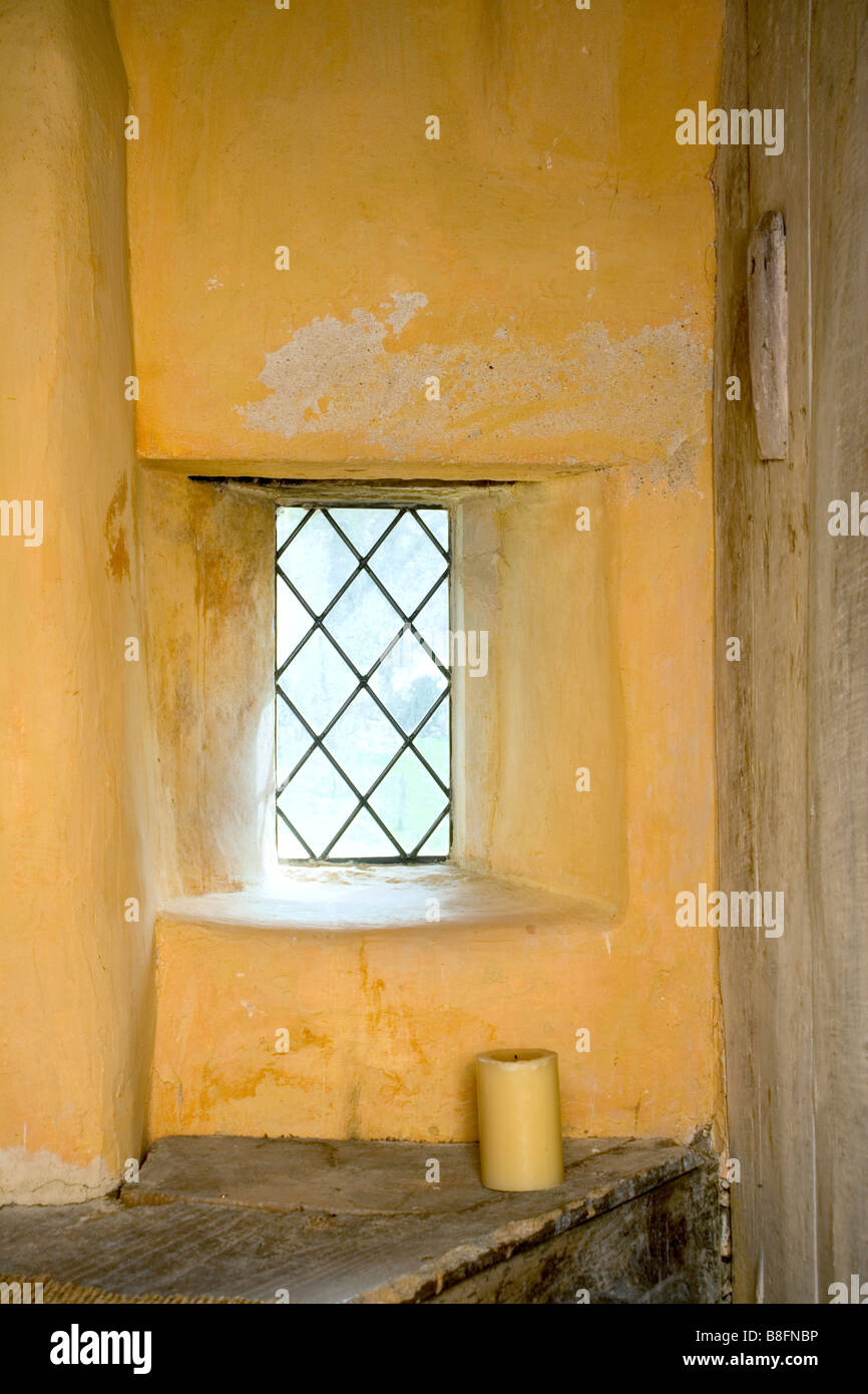 UK. A tiny very old leaded light window feature. Stock Photo
