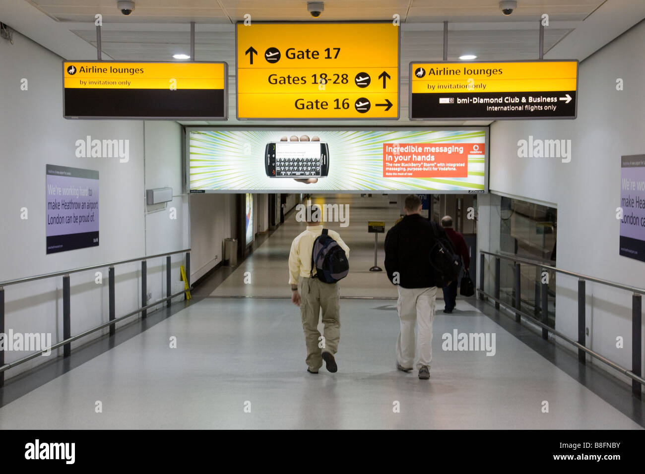 travellers walking to their departure gates, Terminal 1, Heathrow Airport, London UK Stock Photo