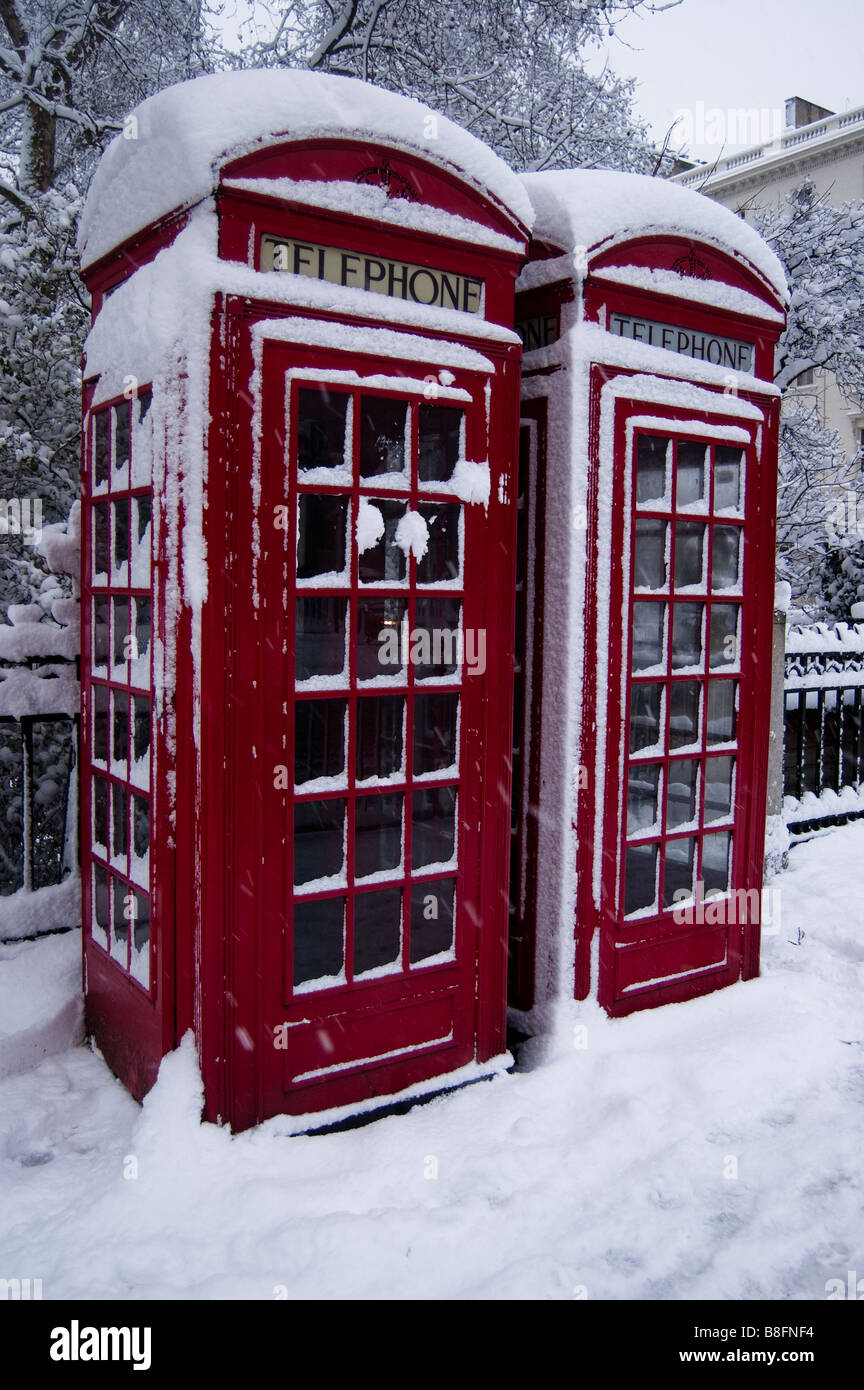 A red telephone box with snow Stock Photo