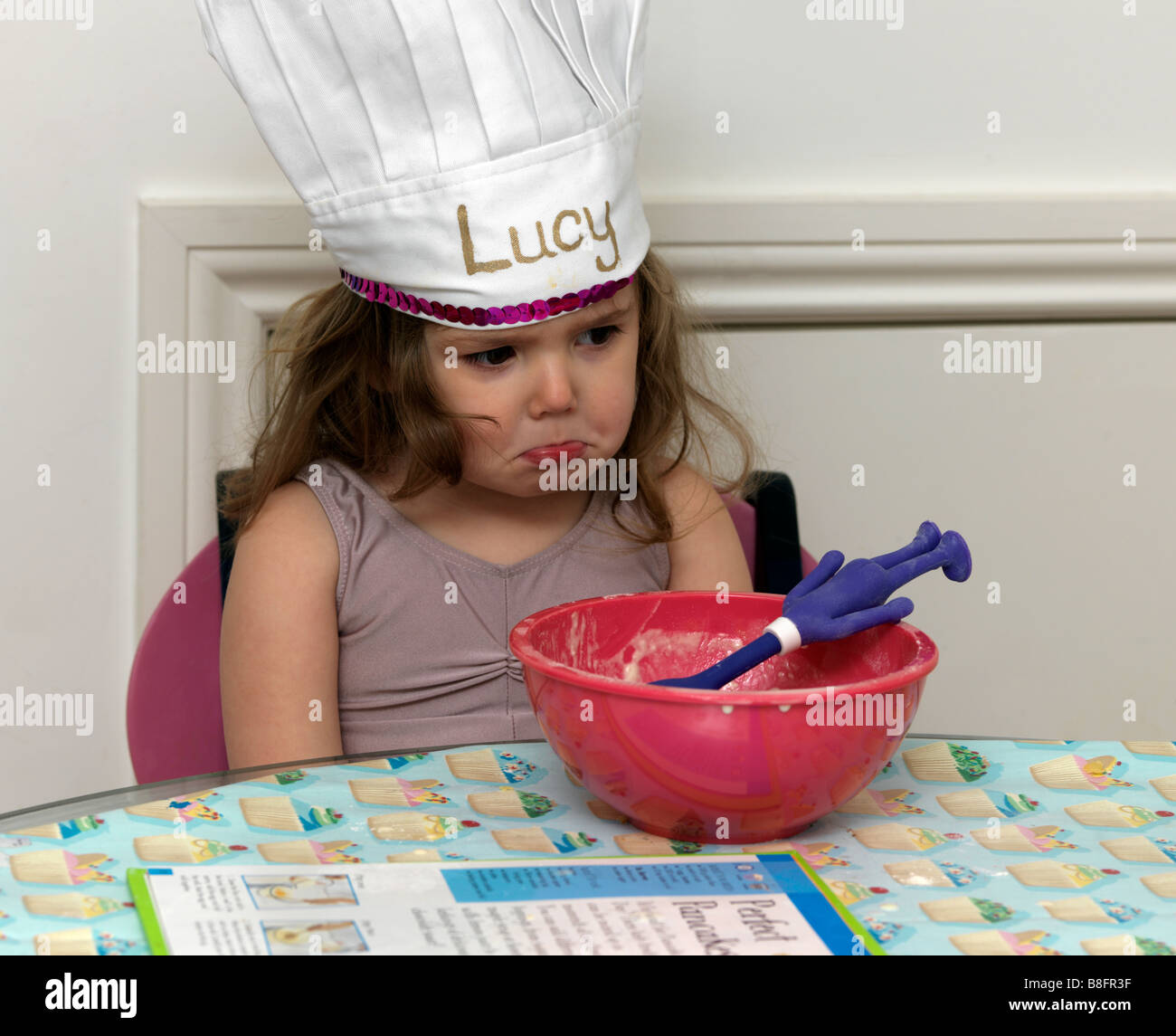 Making Pancakes on Shrove Tuesday Child with Chef s Hat Pouting Stock Photo