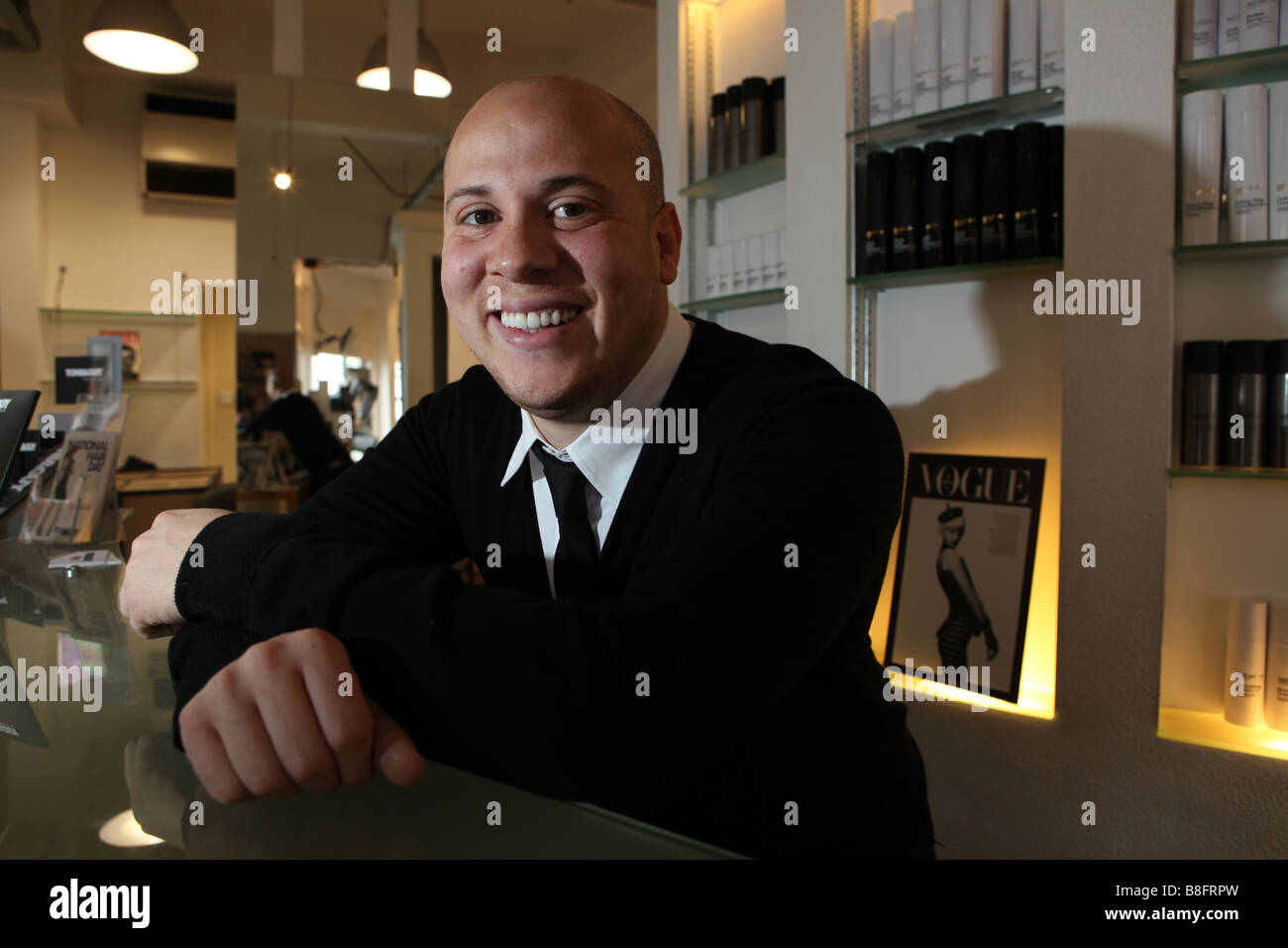A Portrait Of A Male Hairdresser On The Front Desk In His Salon