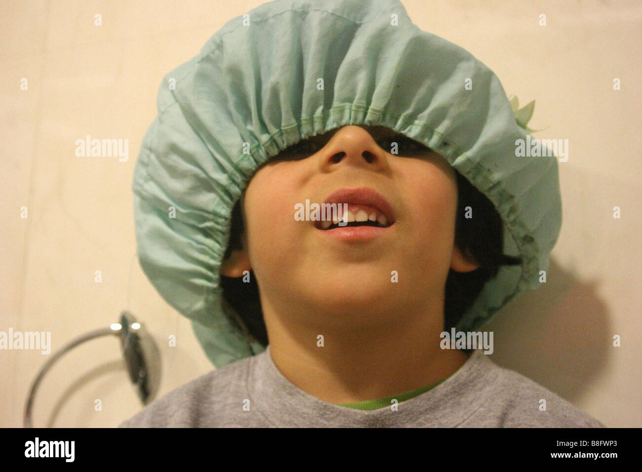 A boy with a shower cap on his head Stock Photo Alamy