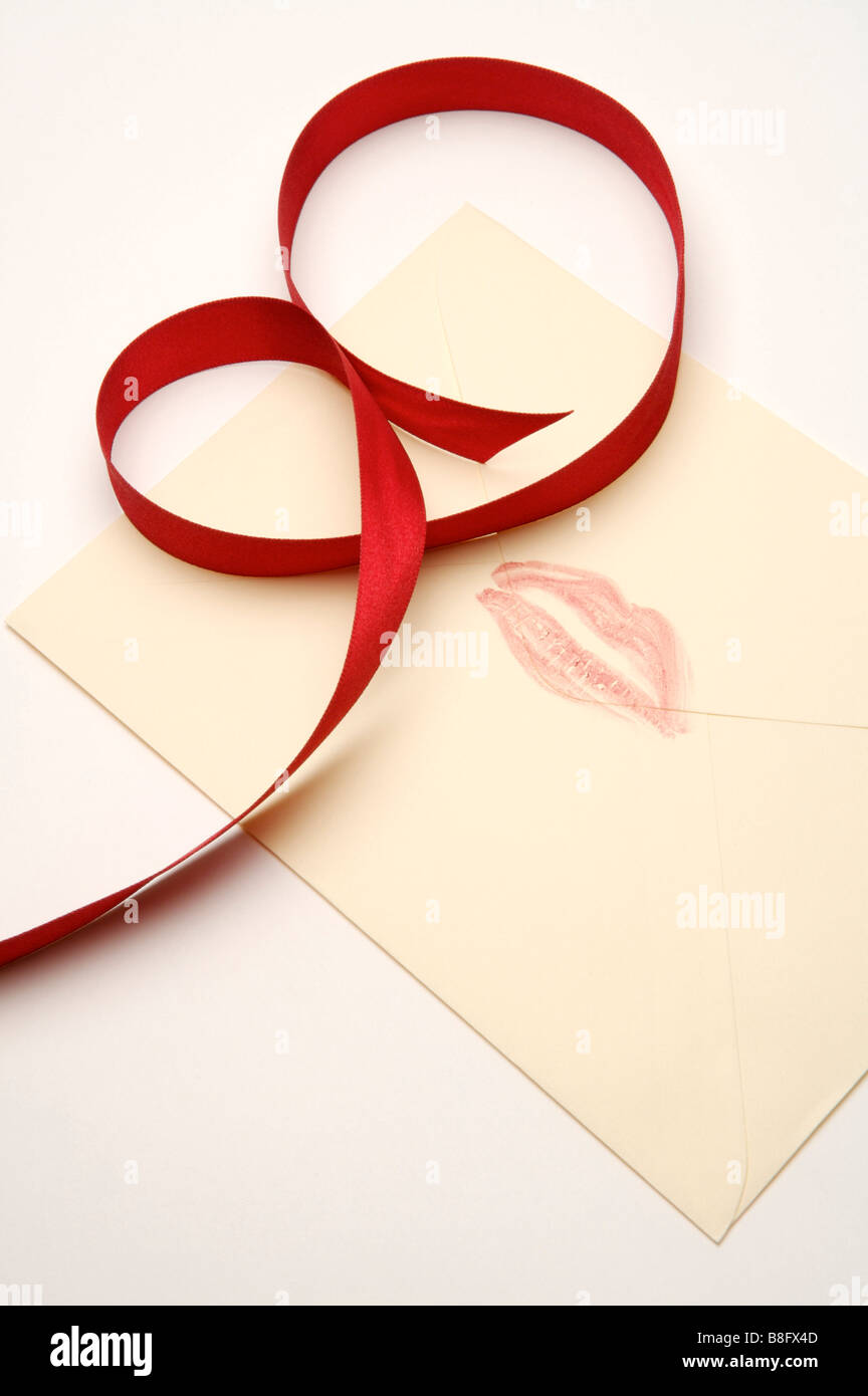 Close up of a red ribbon and human lips on the paper Stock Photo