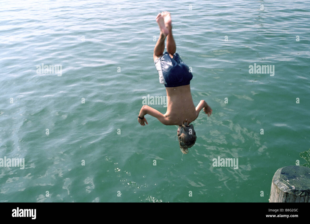 Boy jumping headlong into Water Swimming Leisure Time Youth Stock