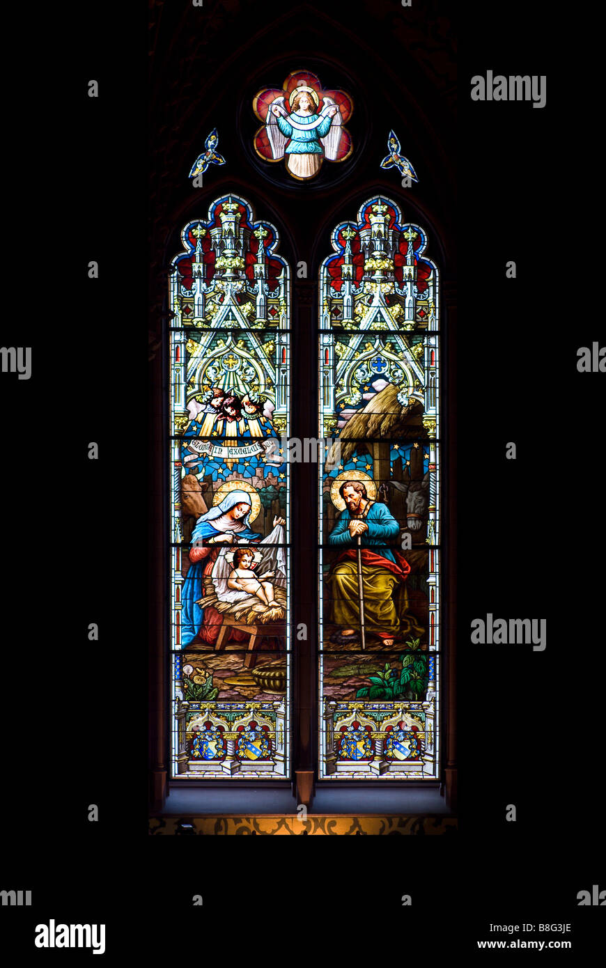 Stained glass window depicting the infant Jesus with Mary and Joesph at ...