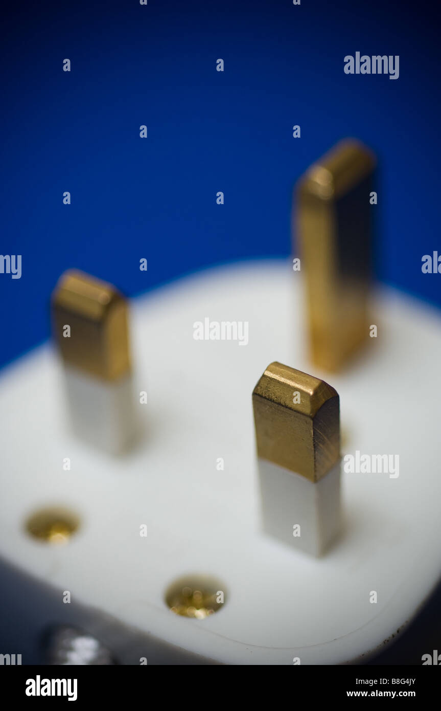 A 240 volt British electrical plug on a blue background Stock Photo