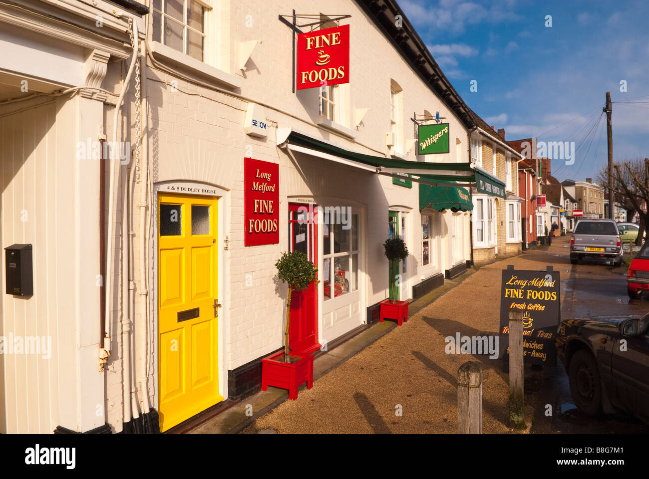 Shops including Long Melford Fine Foods along the main street in Long