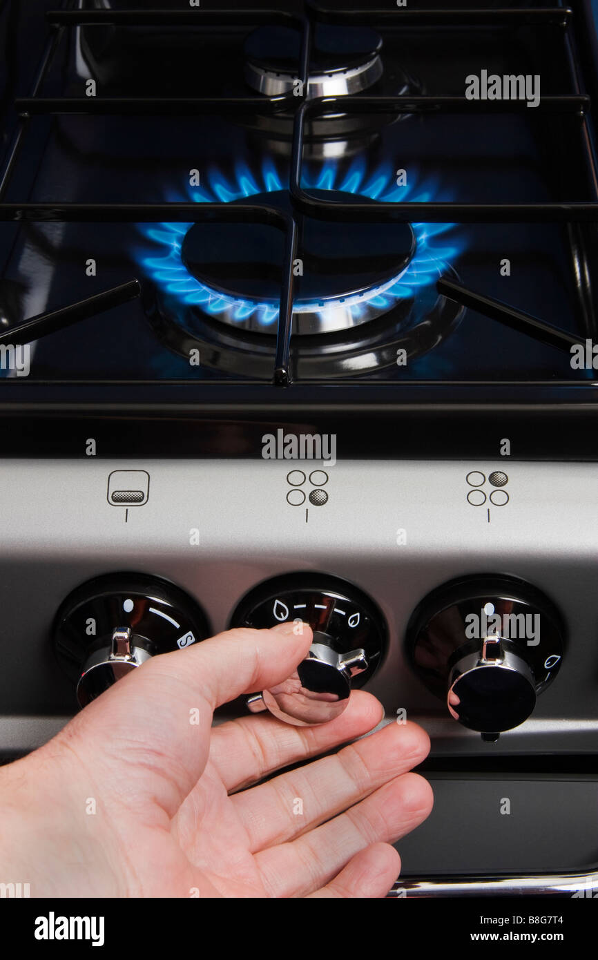 Adjusting a gas cooker burner Stock Photo Alamy