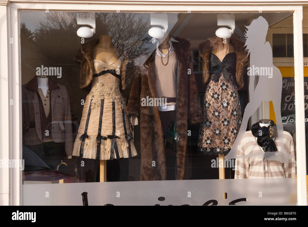 A shop window displaying womens fur coats and other expensive clothes