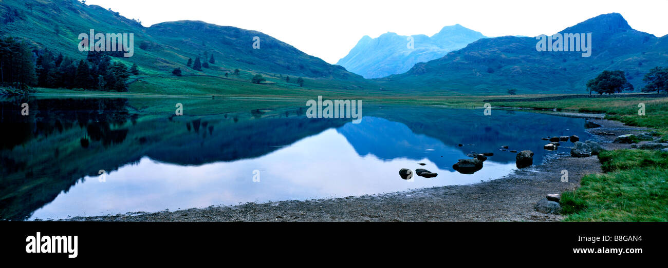 Panoramic view across Blea Tarn to Langdale Pikes in the Lake District Stock Photo
