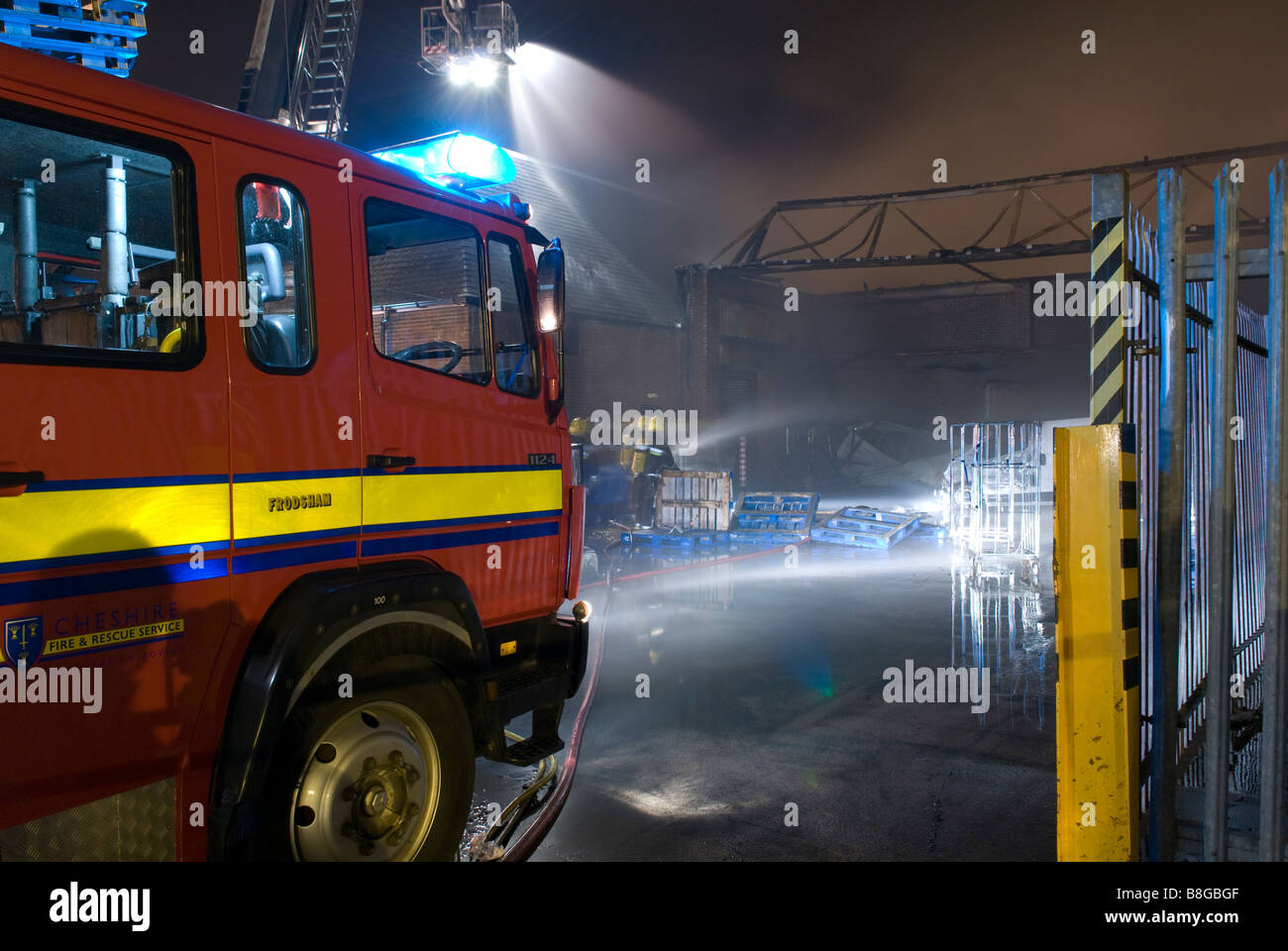 Fire Engine / Appliance at night at fire with headlights on Stock Photo