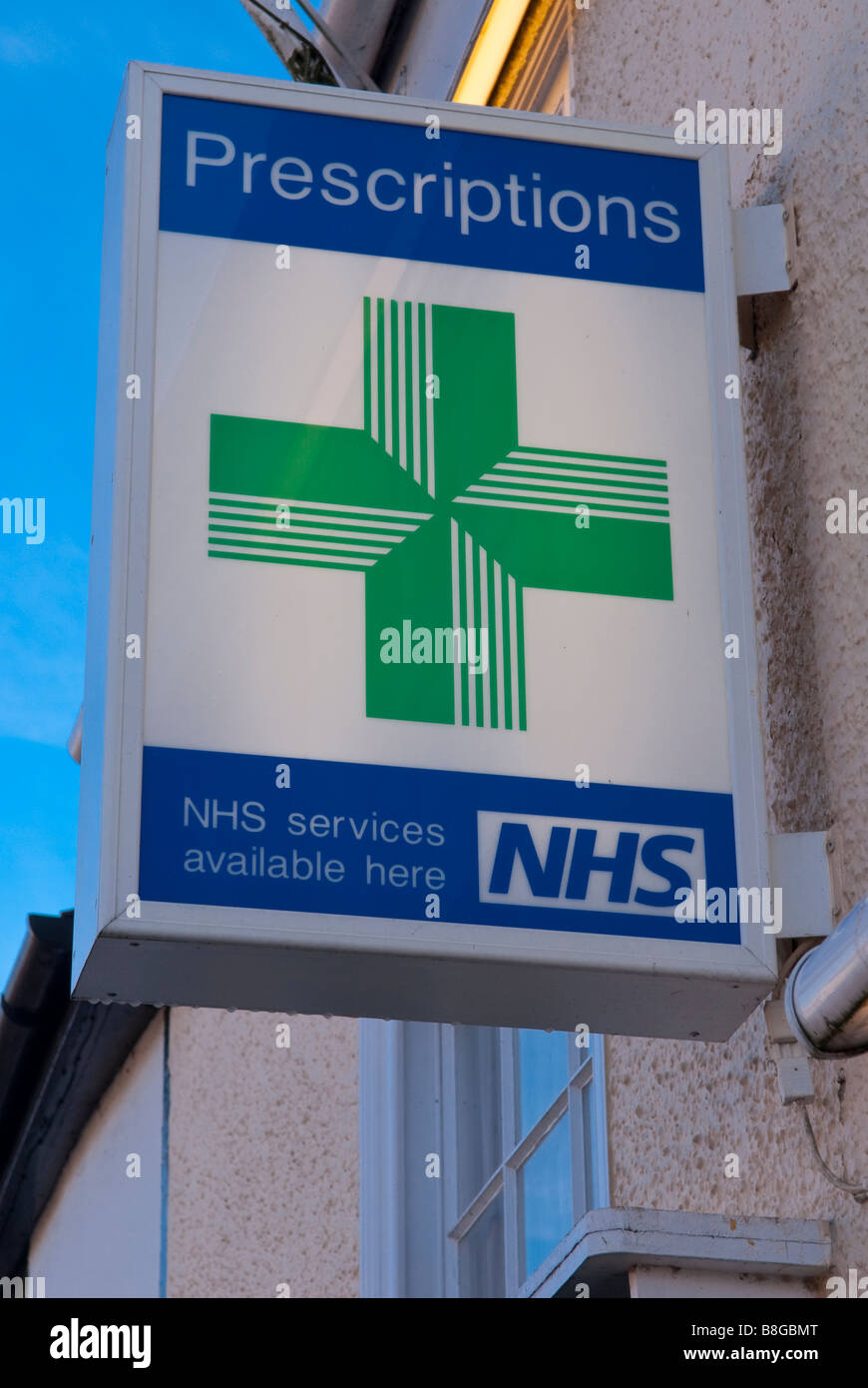 A sign outside a uk pharmacy advertising prescriptions and nhs services available here Stock Photo