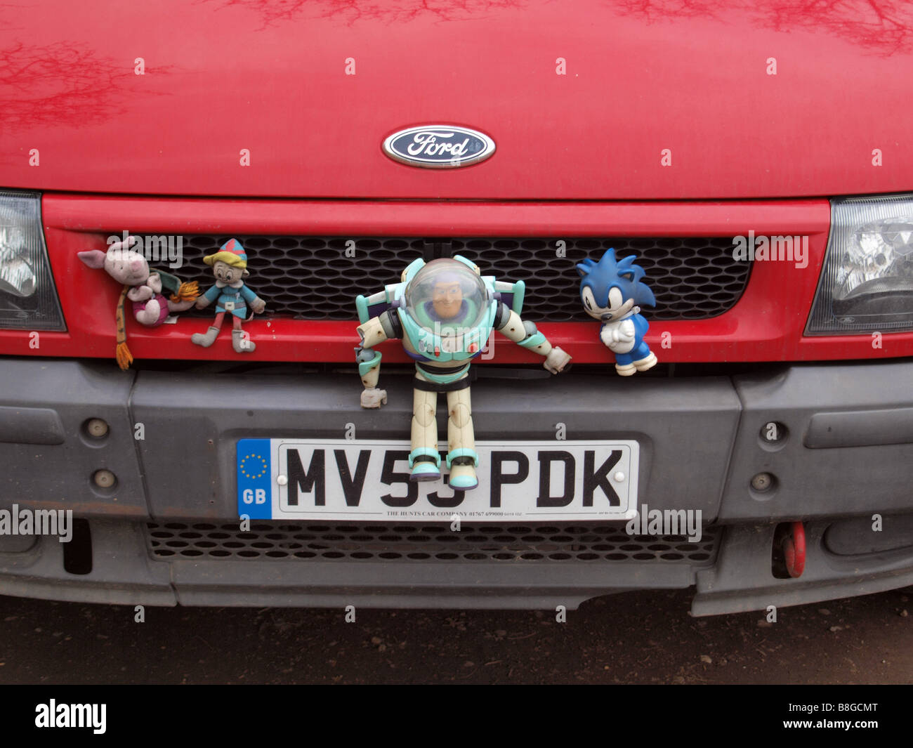 Soft toys on the front of a red van Stock Photo Alamy