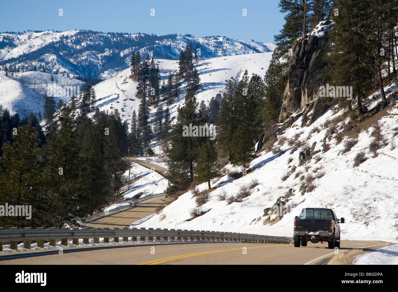 Truck traveling along South Fork of Payette River during winter in Boise County Idaho Stock Photo