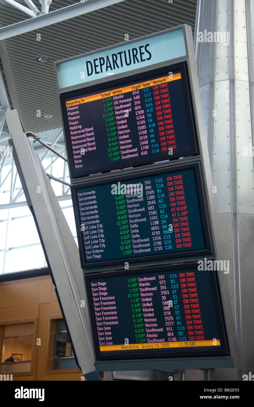Airline departure notice board at the Portland International Airport in Portland Oregon USA Stock Photo