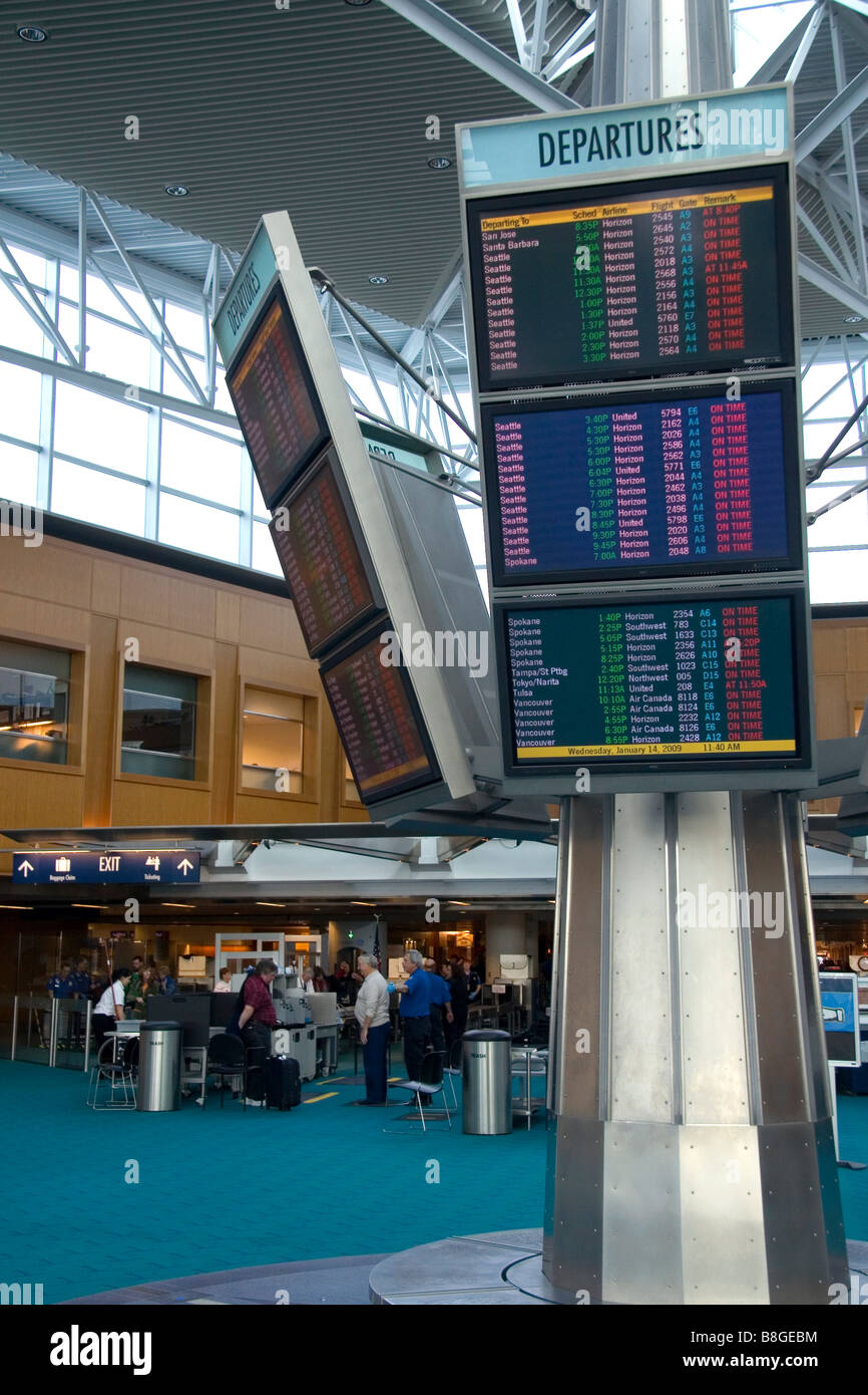 Airline departure notice board at the Portland International Airport in Portland Oregon USA Stock Photo