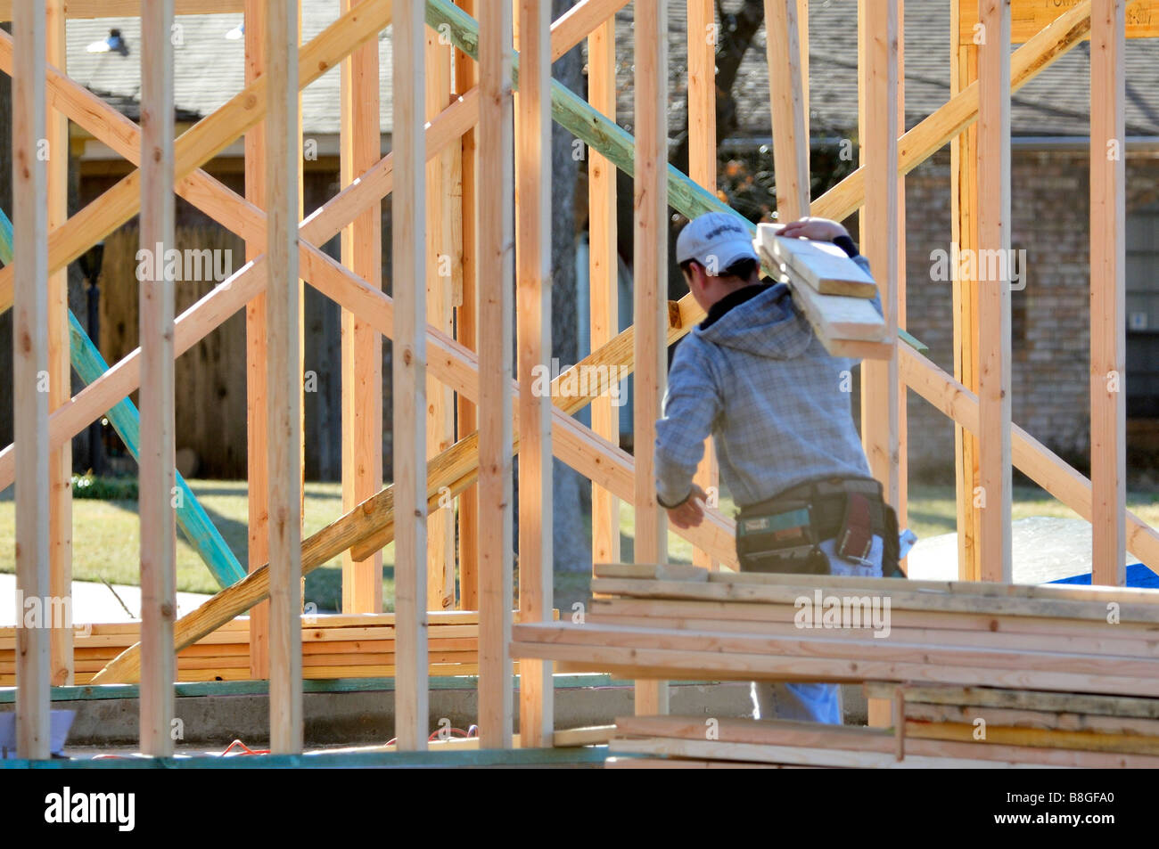A young workman carrying boards for new housing construction. Oklahoma