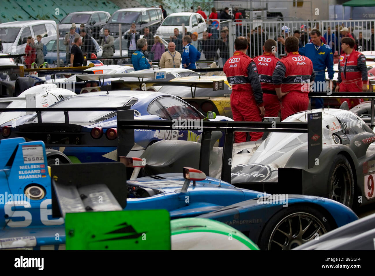 The 24-Hour Le Man racing cars parked together at the end of the race with members of the Audi team talking to officials. Stock Photo