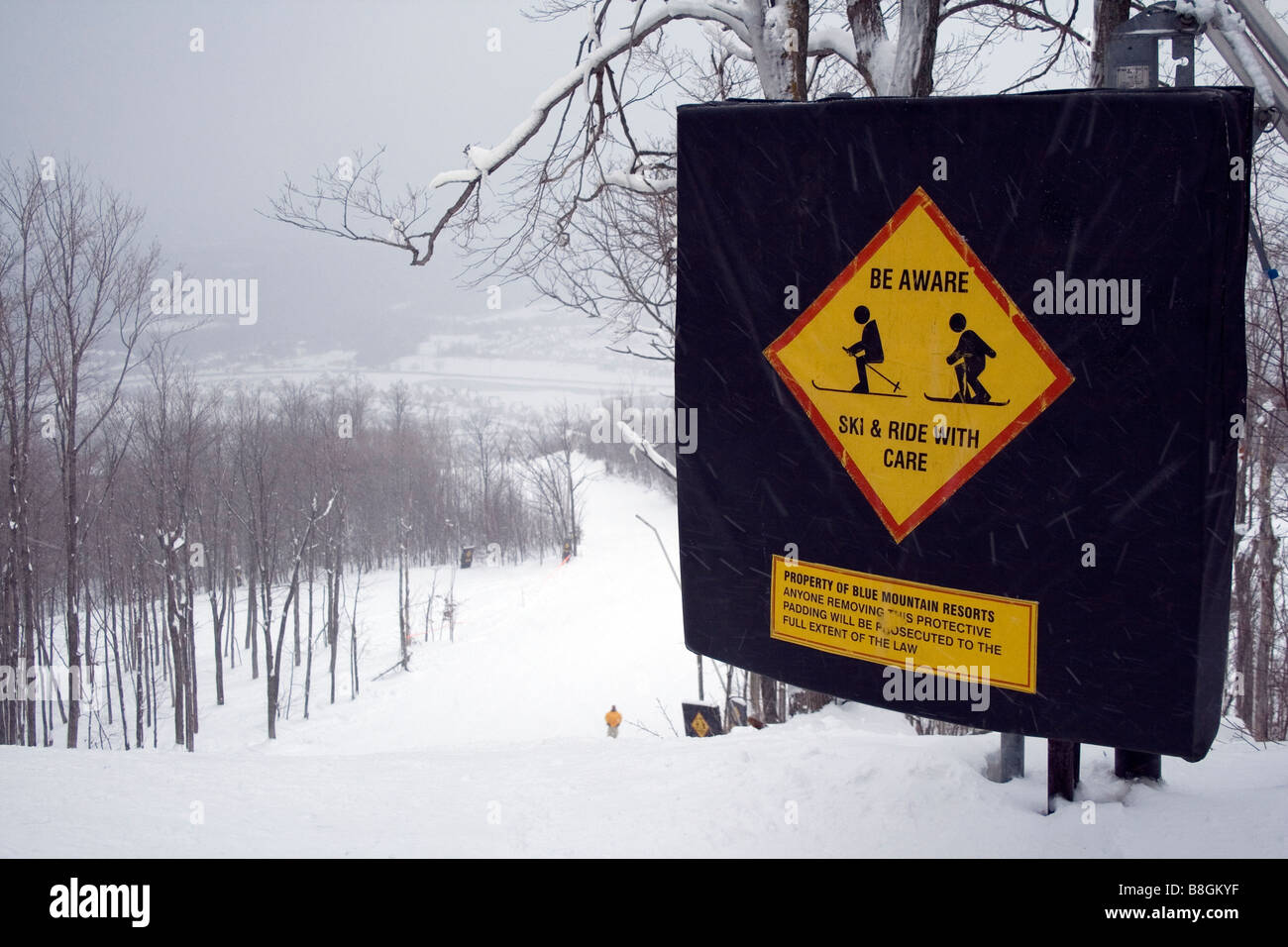 Be Aware, Ski & Ride with Care sign at top of Ski run- Blue Mountains Ski Resort Stock Photo
