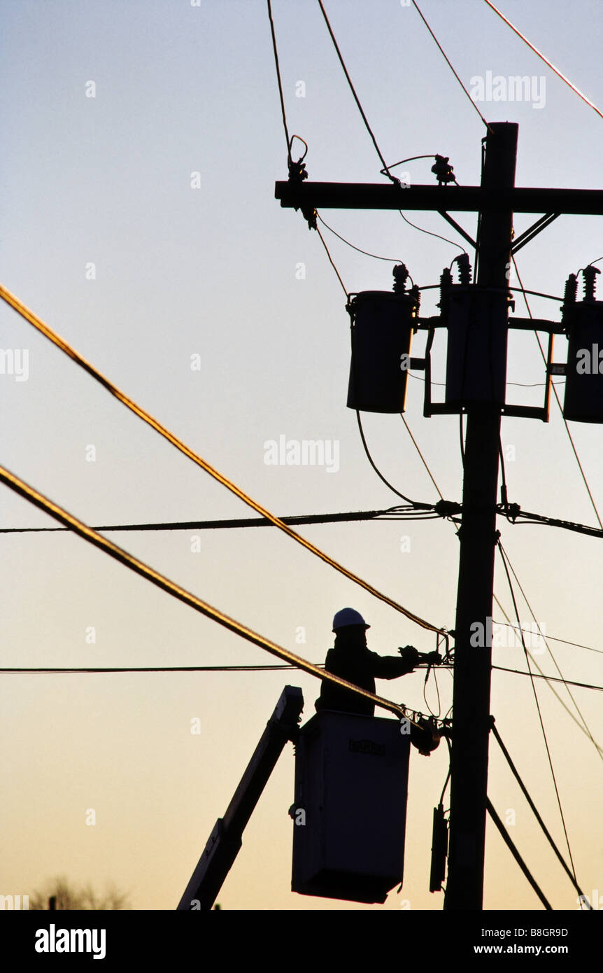 People working,telephone lineman working on telephone pole, in bucket