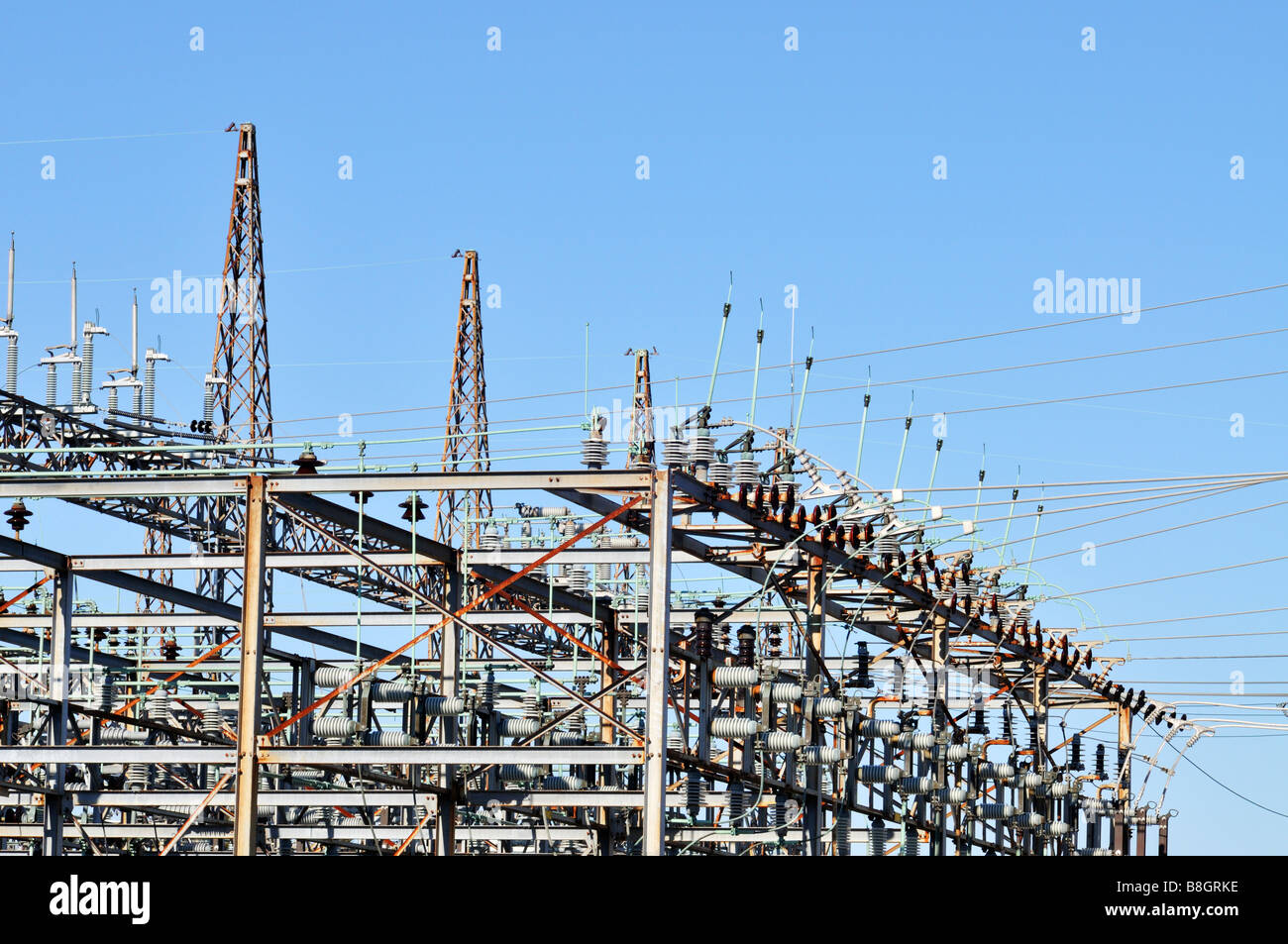 Electric power substation for transmission grid with switch tower circuit breakers switches and lightning rods Stock Photo