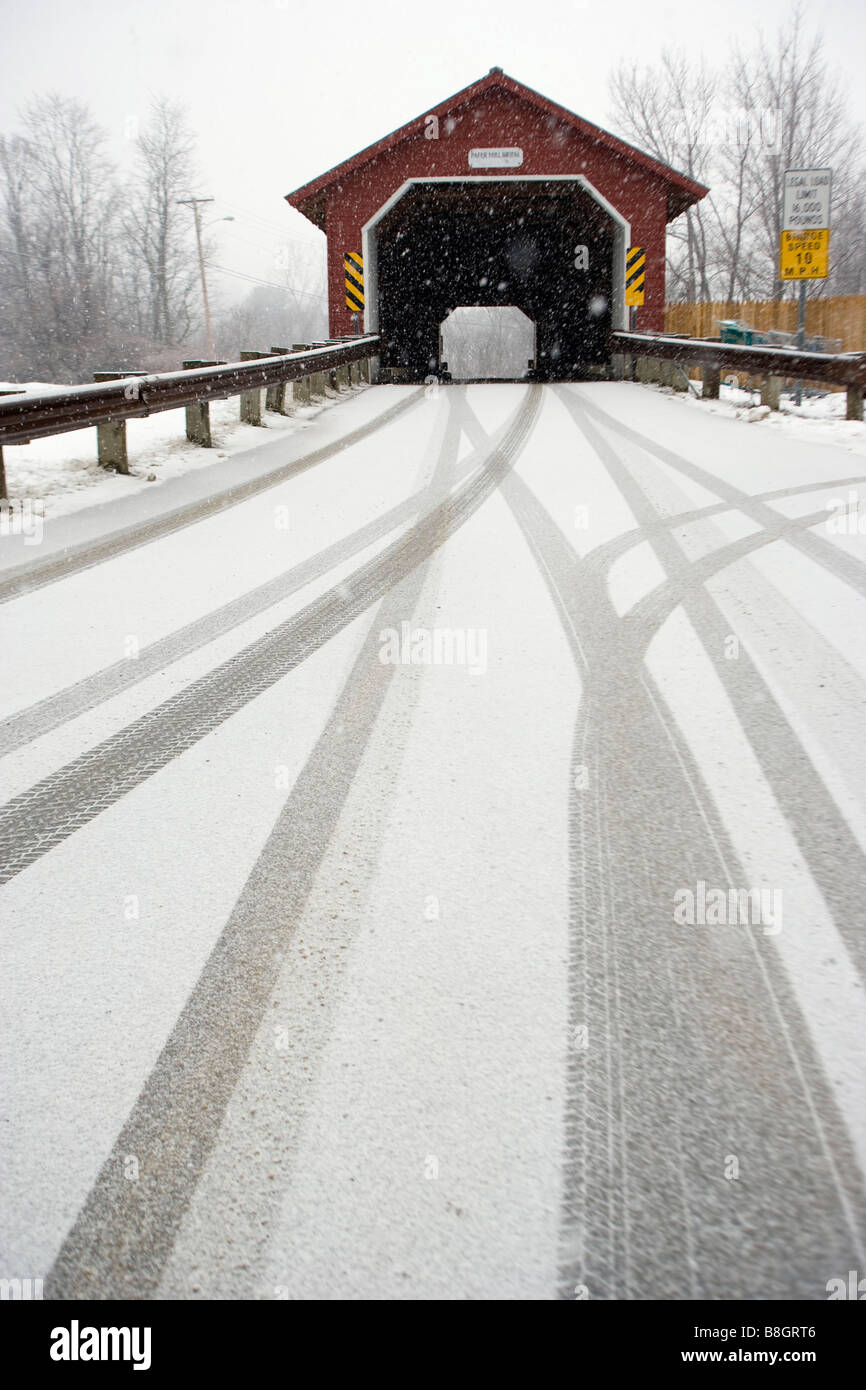 a covered Vermont bridge with tire tracks in the snow Stock Photo Alamy