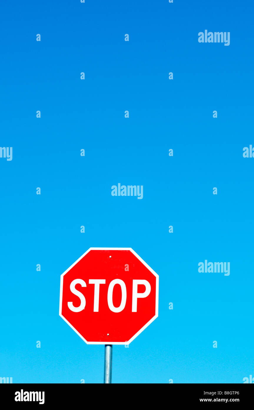 Stop sign red and white against clear deep blue sky Stock Photo