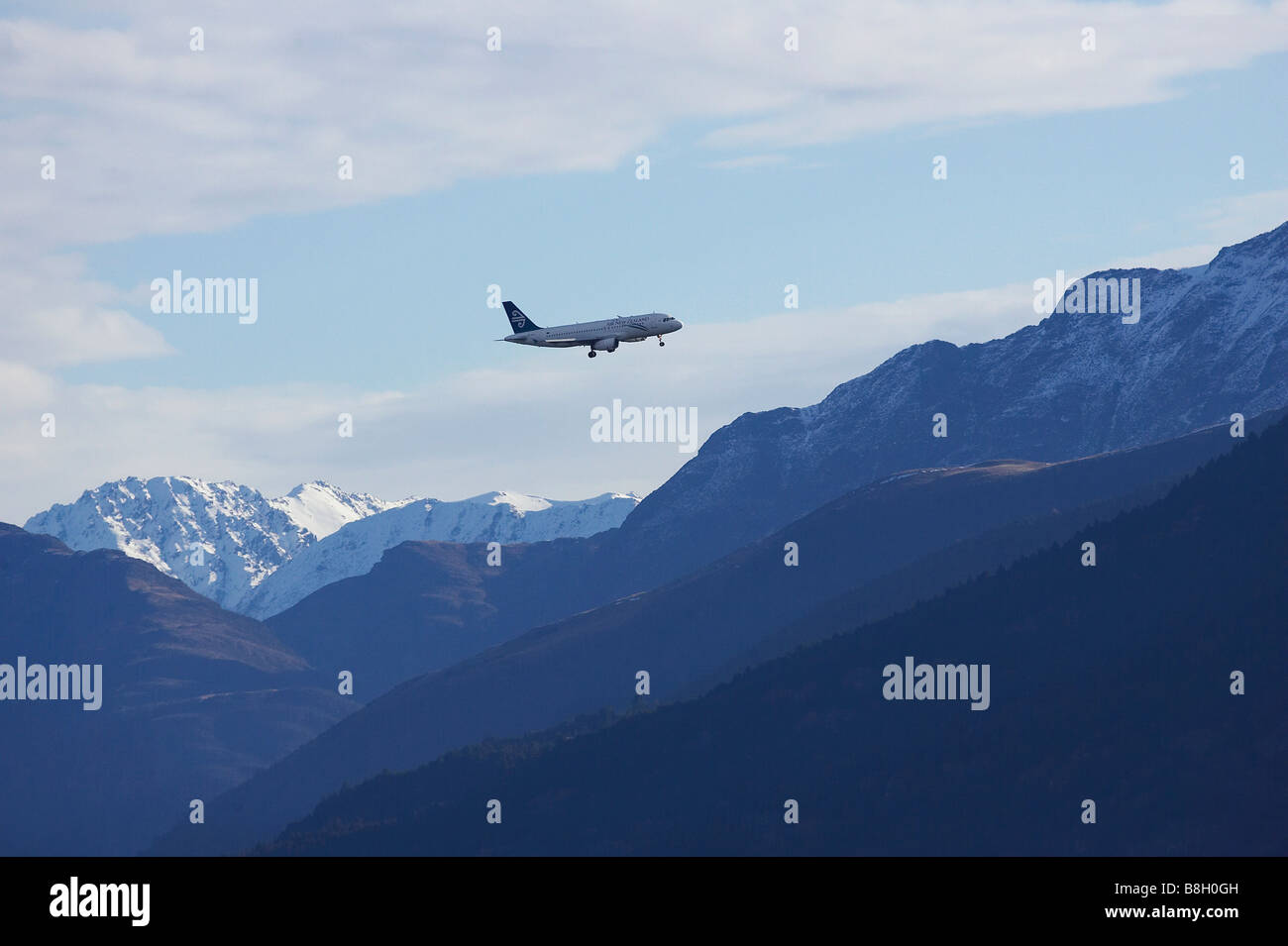 Air New Zealand Jet over Snowy Mountains near Queenstown South Island New Zealand Stock Photo