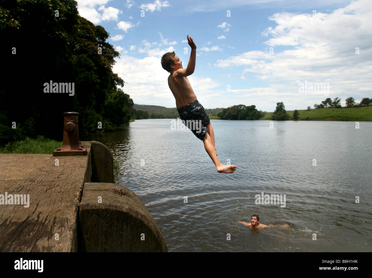 Two boys playing in the Manning river near Wingham in Australia Stock Photo