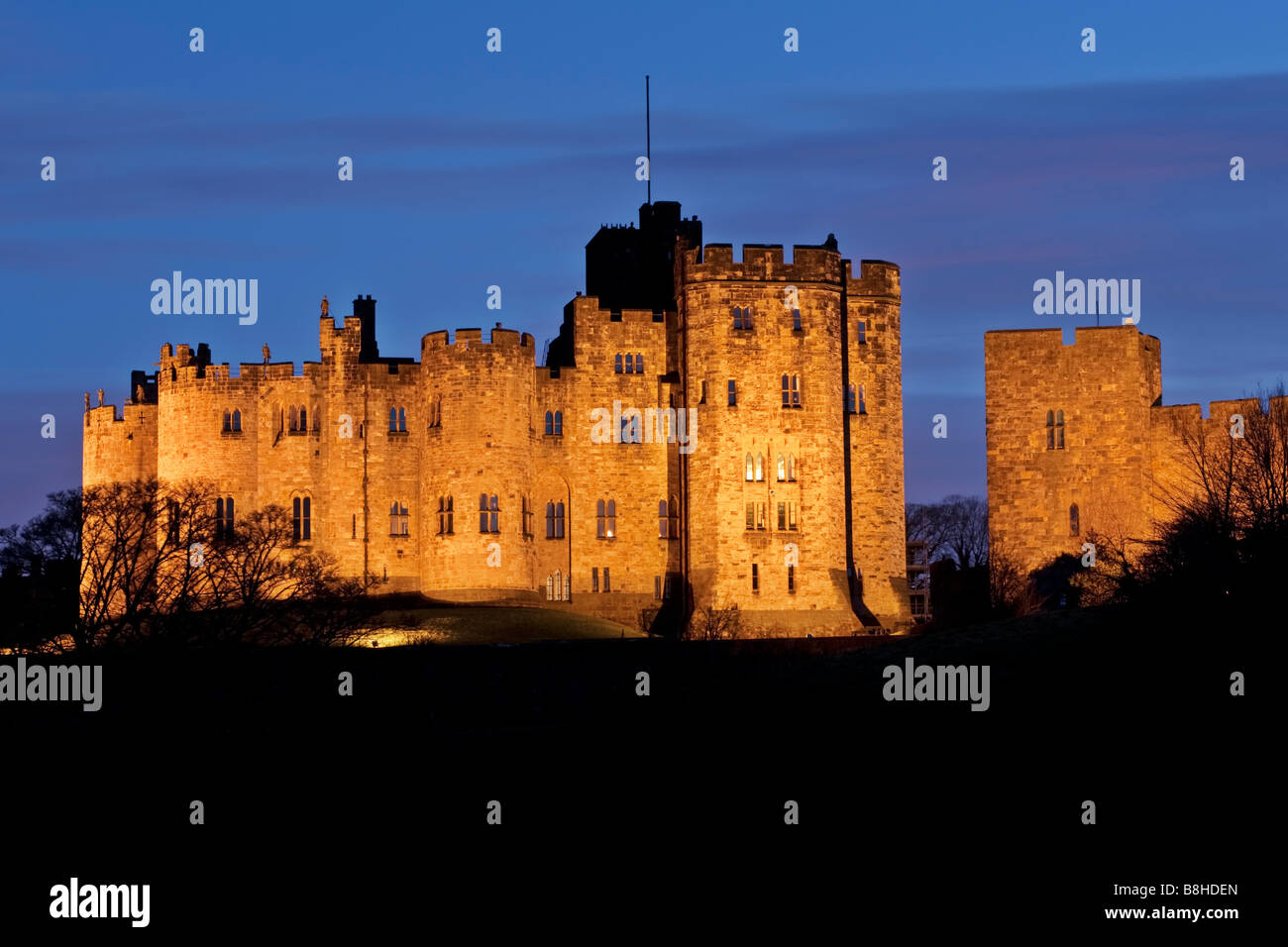 A floodlit Alnwick Castle, home to the Duke and Duchess of Northumberland Stock Photo