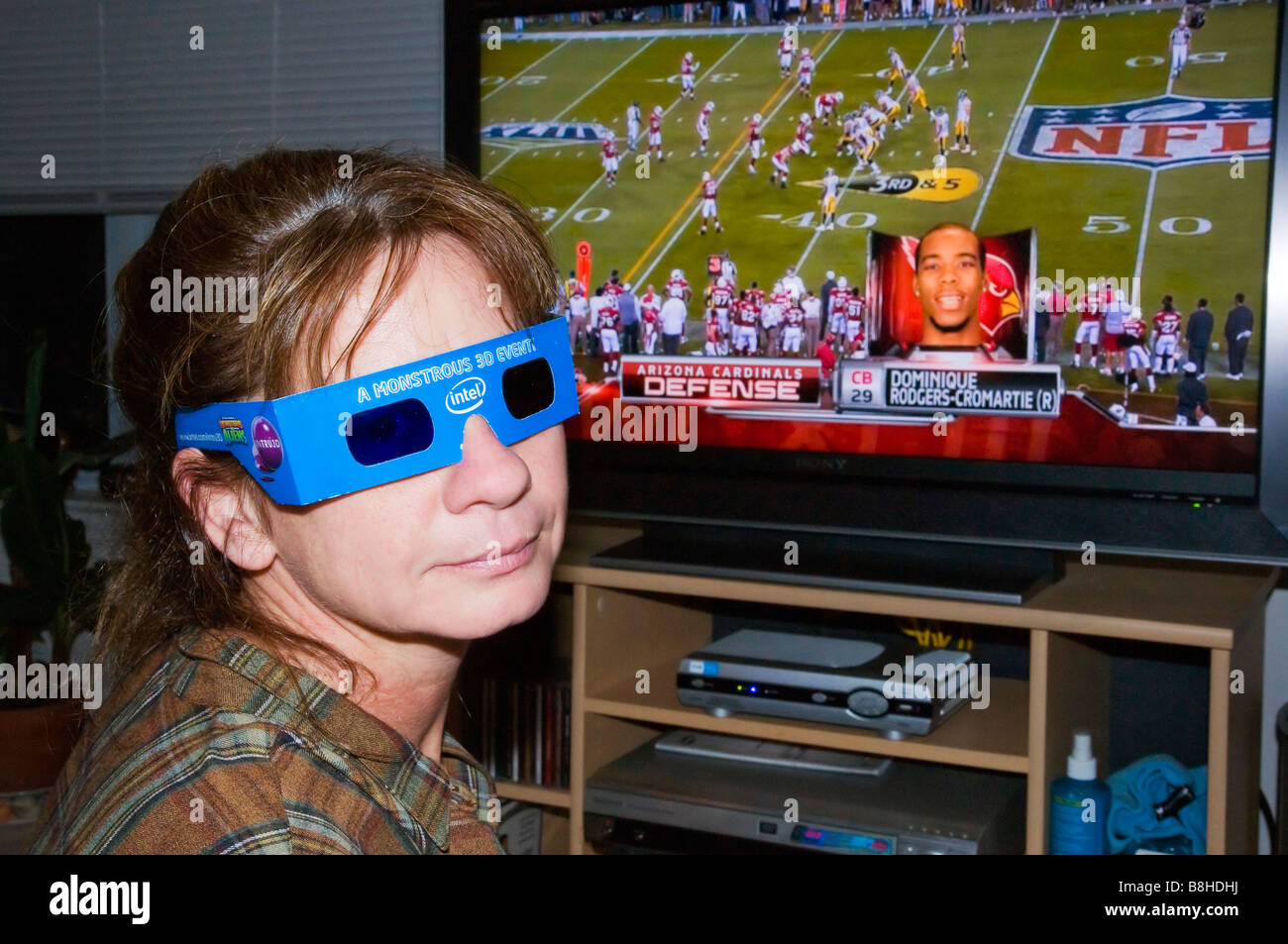 Woman wearing 3D glasses in front of TV with 3D Superbowl playing on  television Stock Photo - Alamy