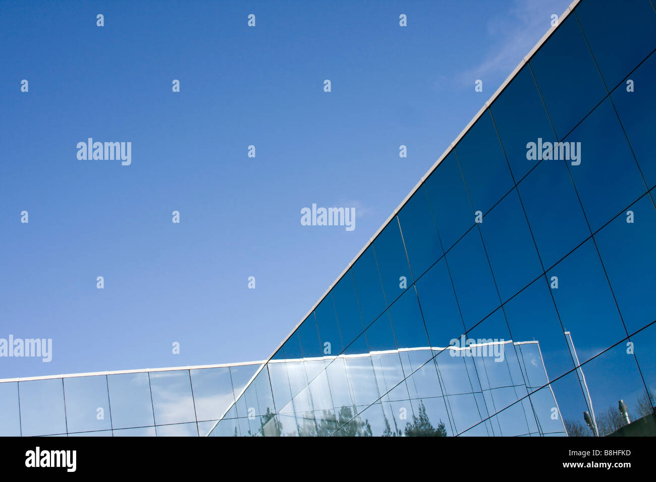 Reflections of the sun in the glass of the modern building. Stock Photo