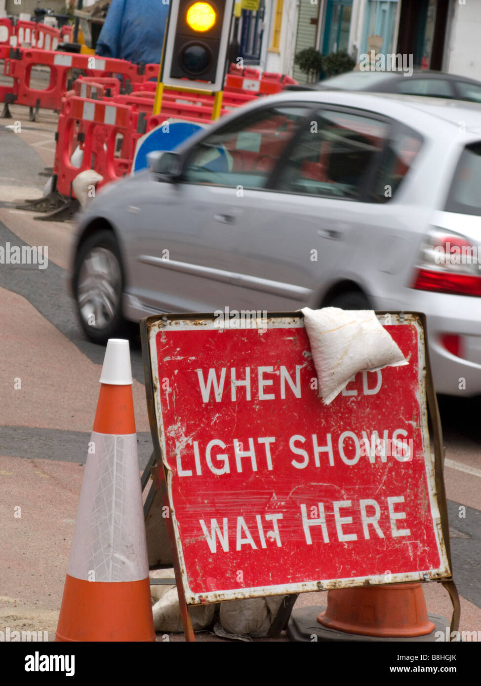 Car just making the changing traffic lights at roadworks in London, UK. Stock Photo