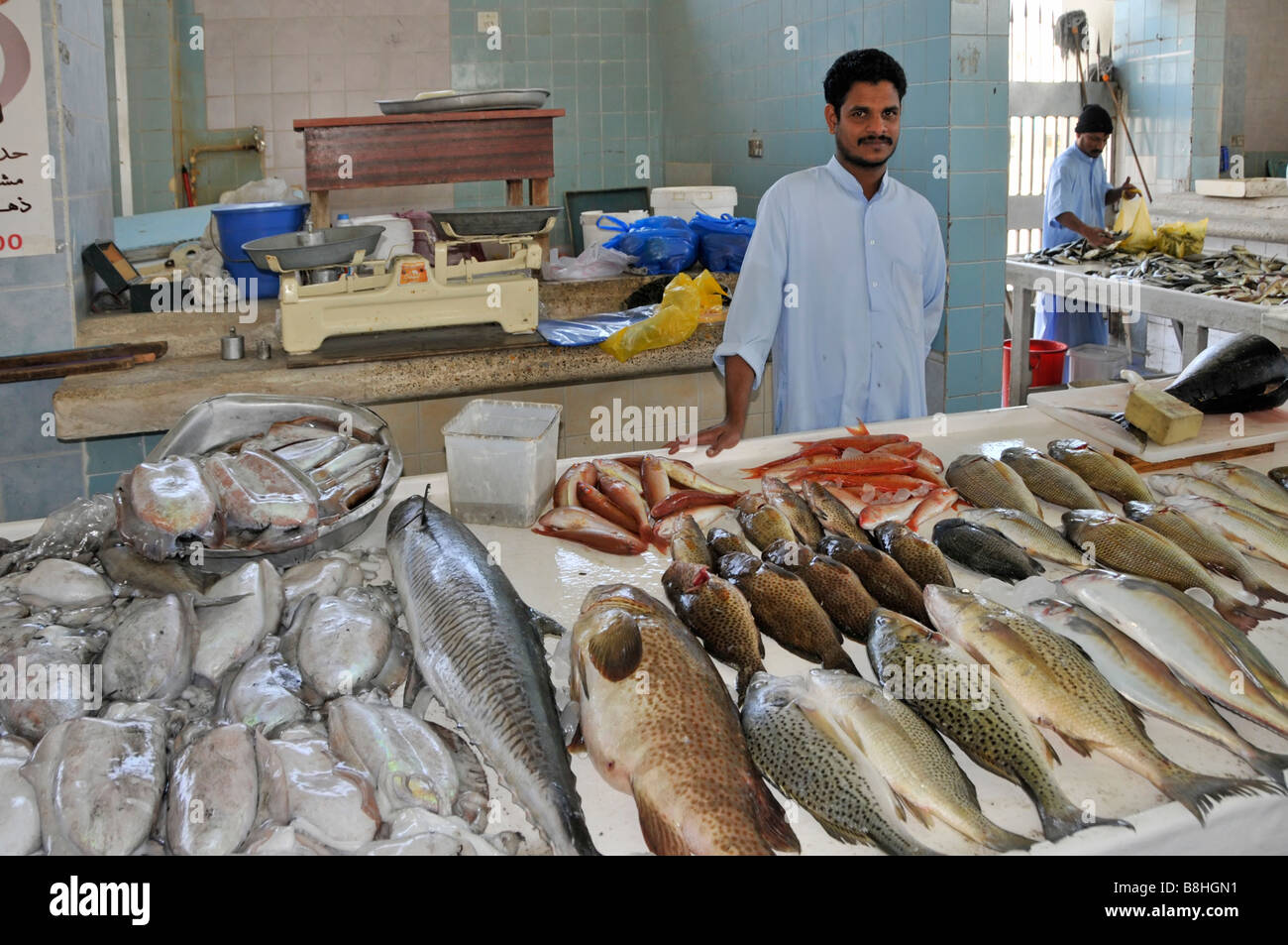 Fish displays and fishmonger vendors at work in Fujairah fish market
