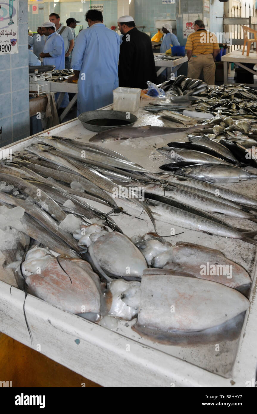 Fish displays and fishmonger vendors at work in Fujairah fish market