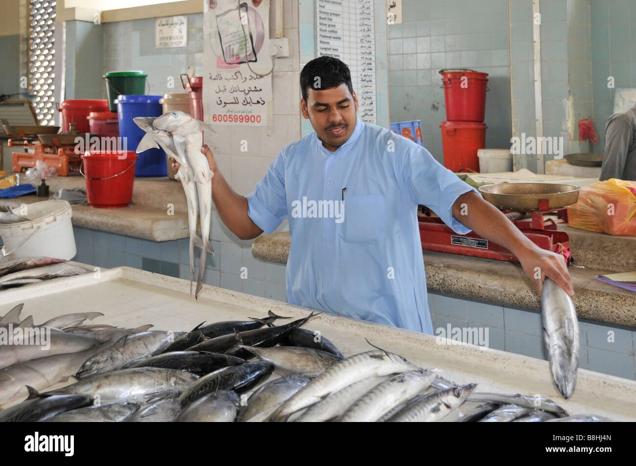 Fish displays and fishmonger vendors at work in Fujairah fish market