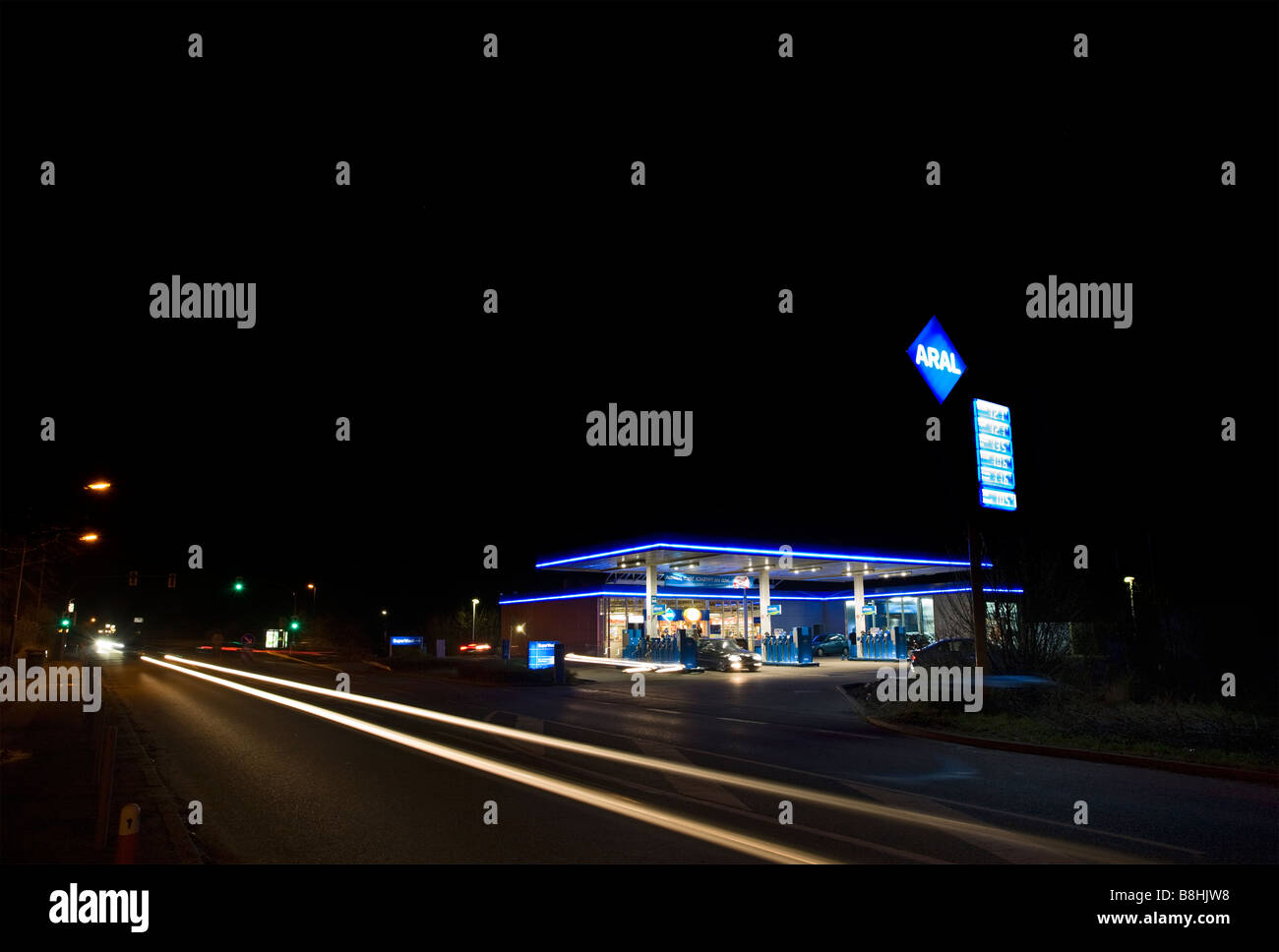 brightly lit Aral gas station at night, long exposure Stock Photo