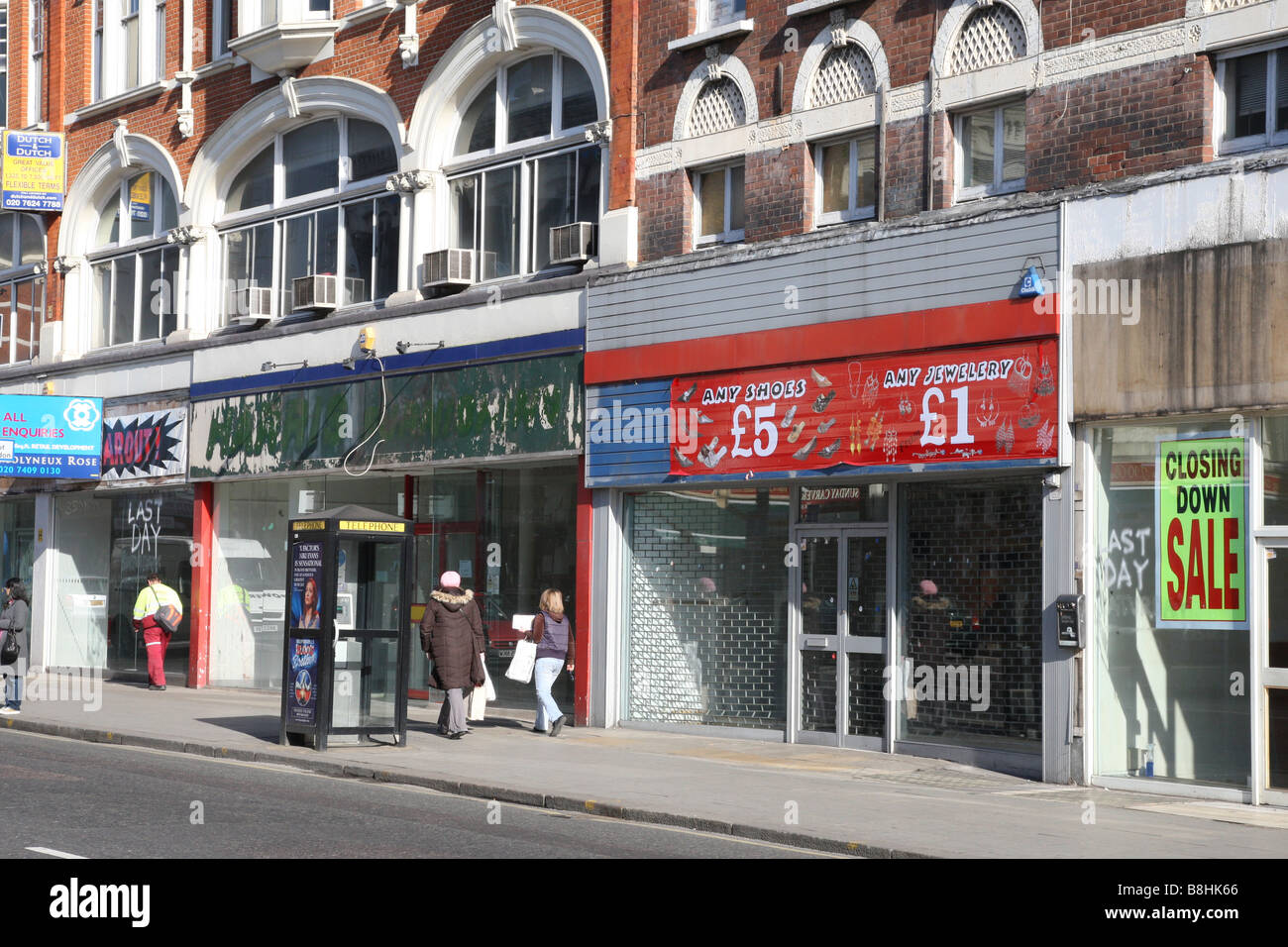 A row of 4 empty shops, recently closed in the harsh economic climate. Kilburn High Road, London. Stock Photo