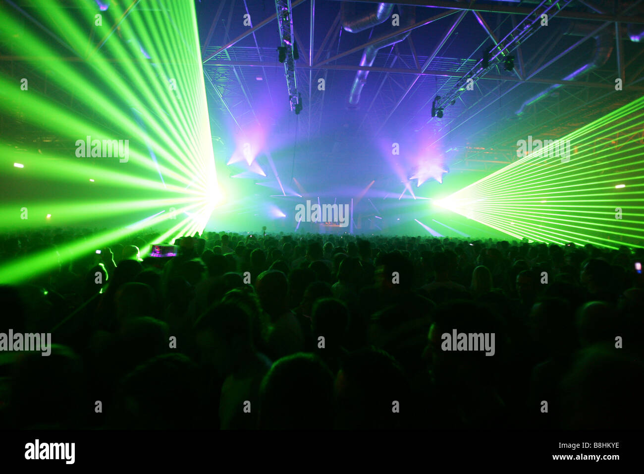 Large crowd and colorful lights and lasers at a houseparty in the Netherlands Stock Photo