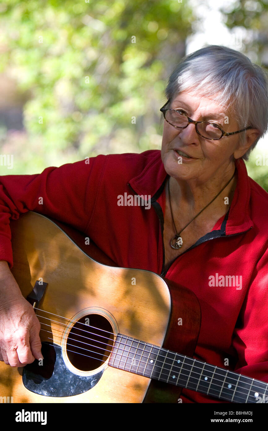 American folk singer songwriter Rosalie Sorrels playing guitar at her home near Boise Idaho Stock Photo