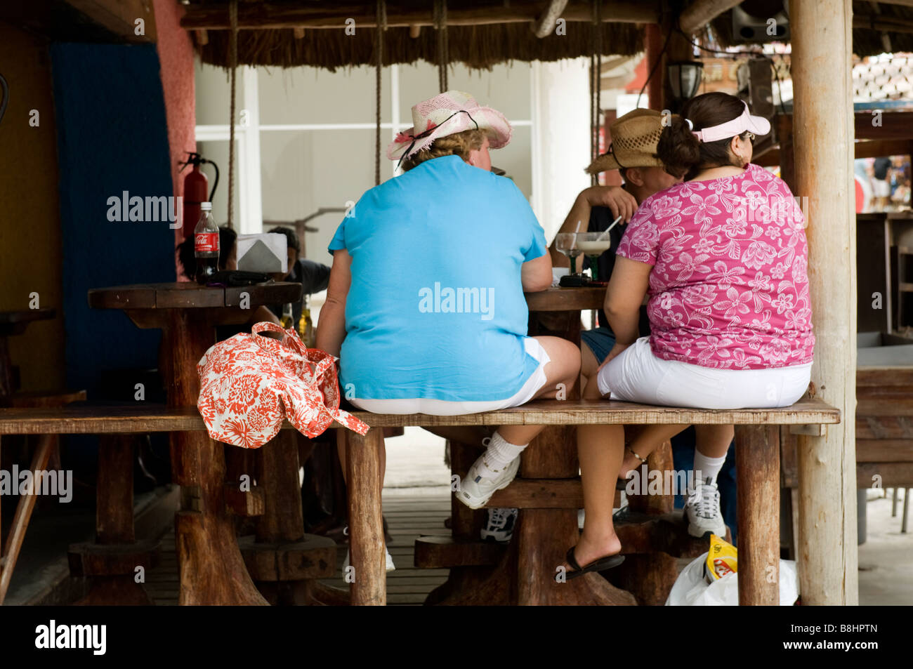 Two American women sat at a bar in Playa del Carmen Mexico Stock Photo