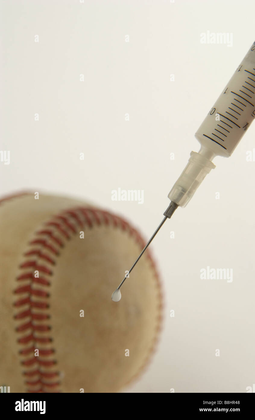 syringe of steroids in front of a baseball Stock Photo