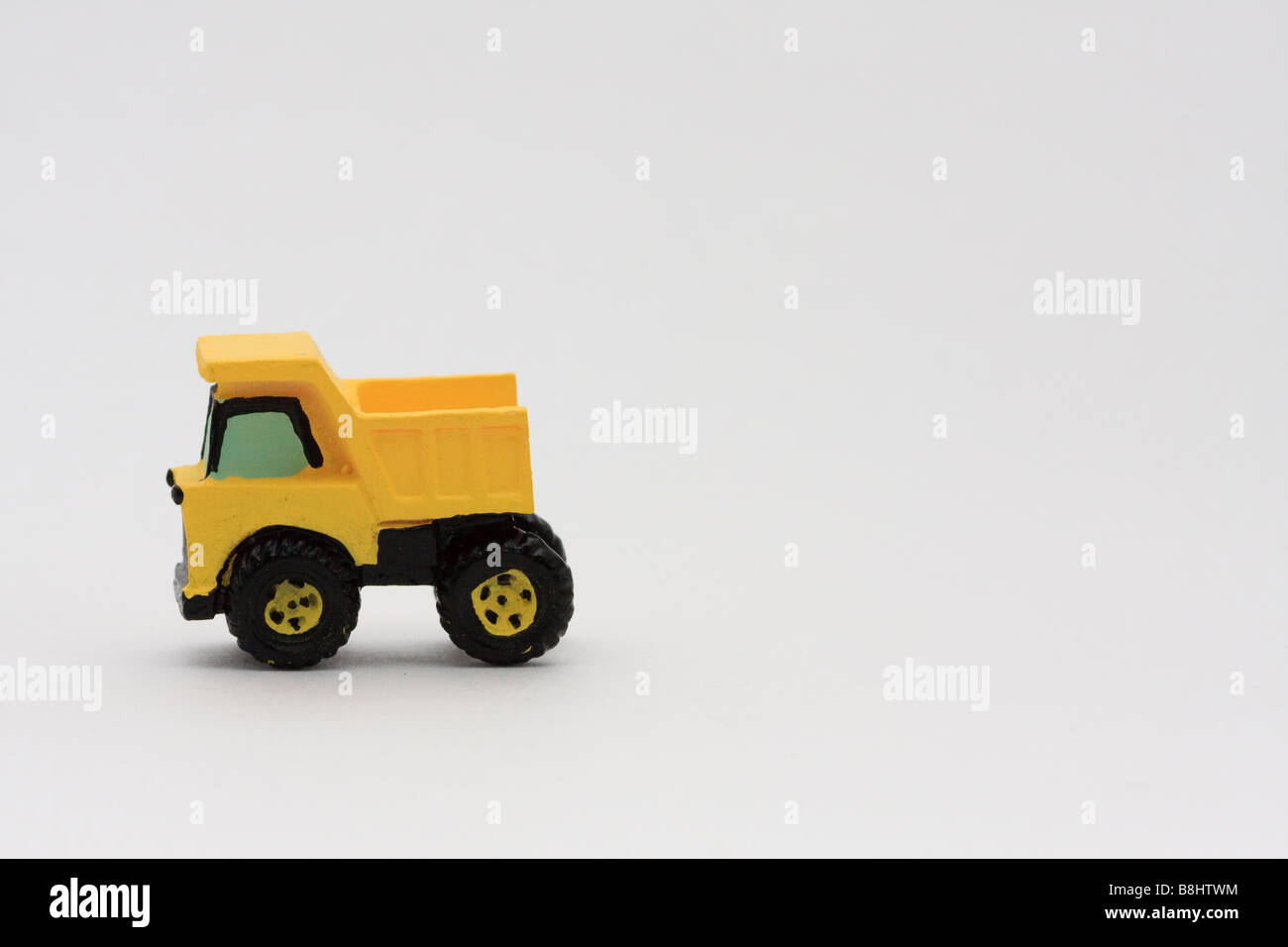 Yellow dump truck on white background Stock Photo - Alamy
